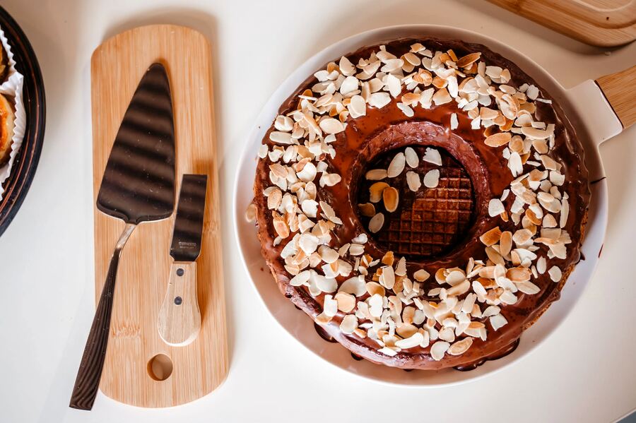 Tort rotund cu glazură de ciocolată, migdale și un stroopwafel în mijloc