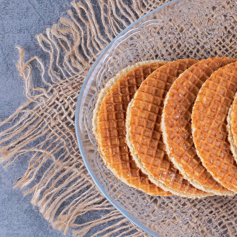 Stroopwafels clasice, nedecorate, așezate pe o farfurie de sticlă